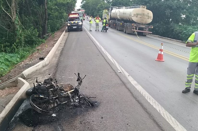 Motociclista morre após bater de frente com carreta e veículo pegar fogo 
